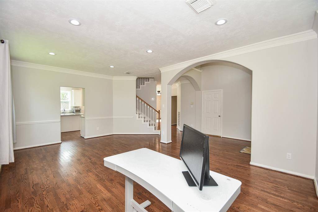 Here's another impressive view from this front formal space to your chef's kitchen, left, and a peek at the staircase to the 2nd level.