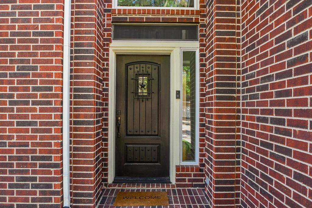 This solidly built front door offers a hearty welcome! Your recessed, brick lined, covered entrance affords privacy and shelter from inclement weather, too.