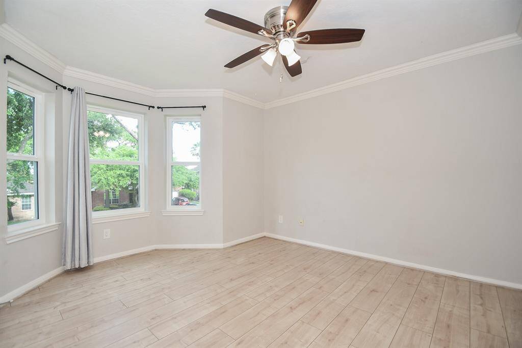 A curved wall of windows is so warming in a large secondary bedroom.
