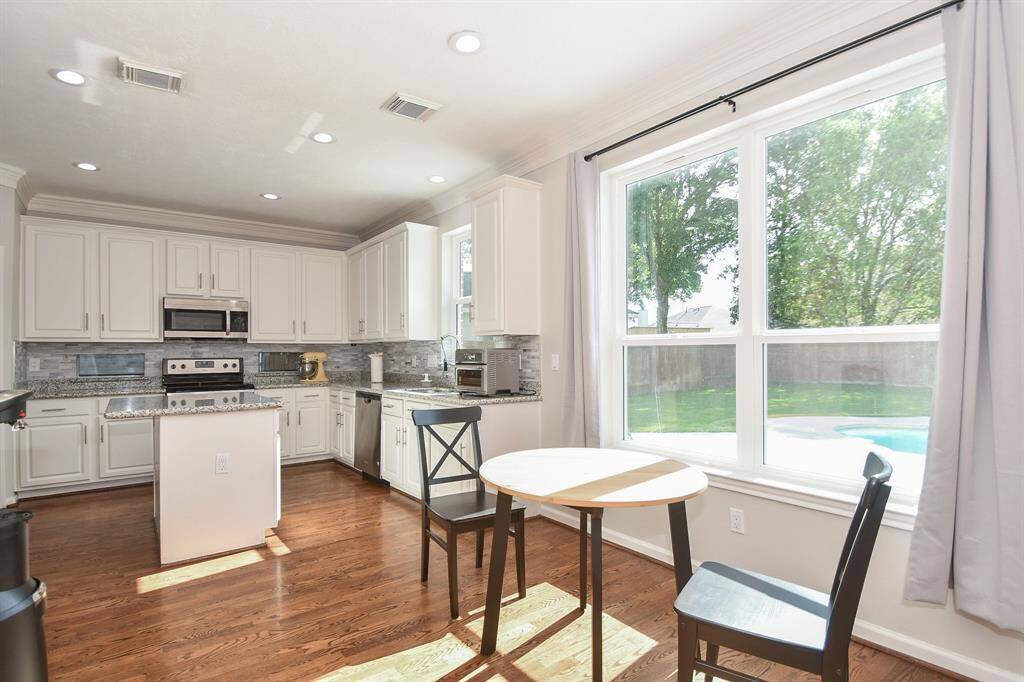 This is the perfect spot for your breakfast nook, just footsteps from the amazing chef's kitchen. There's a kind of old-fashioned comfort that comes in primarily white kitchens, and this one delivers that vibe!