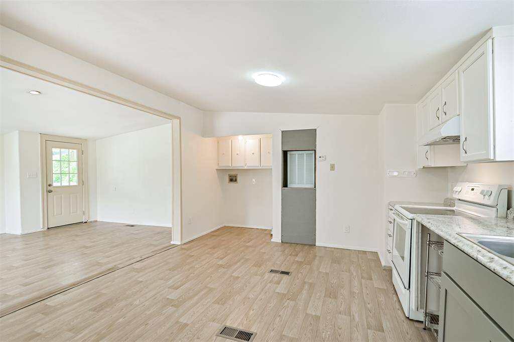 View of kitchen, utility, living area from back/side door area