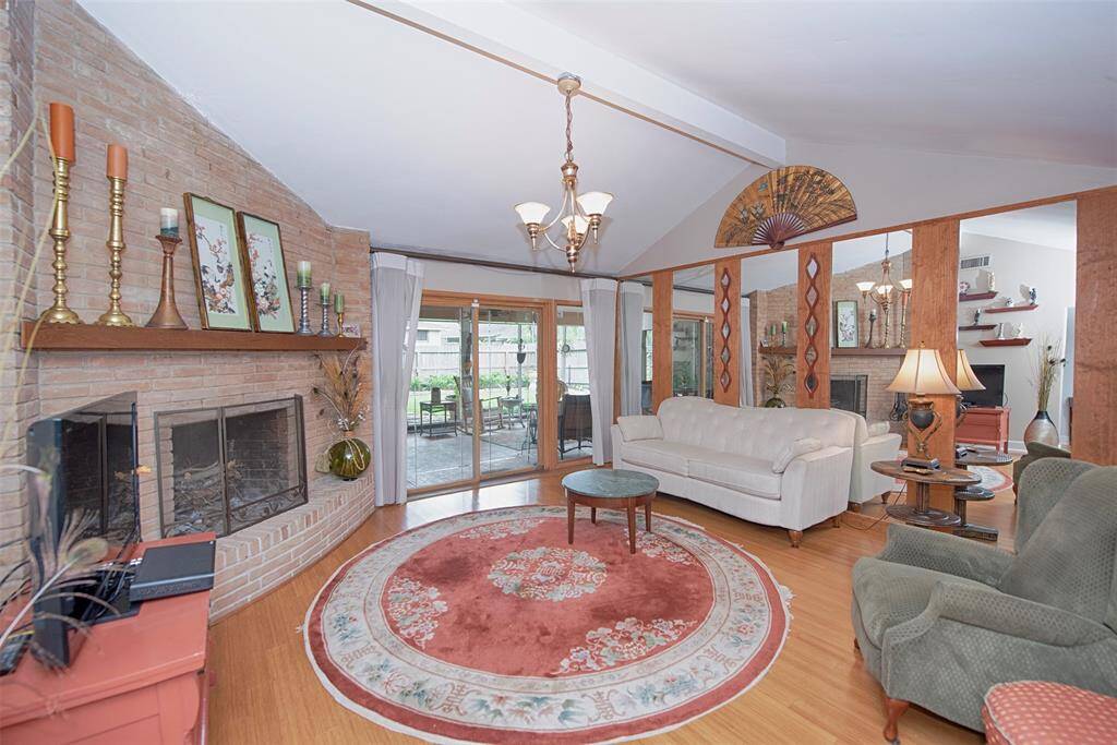 A view of the family room showing a wall of mirrors and access to the back patio.
