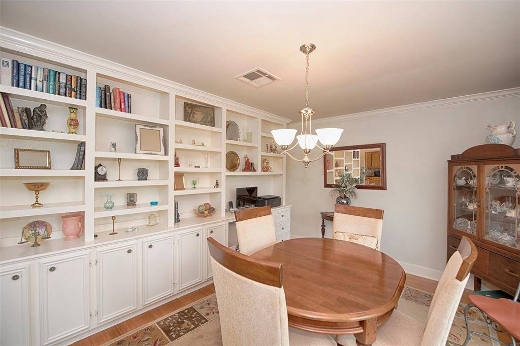 The dining room provides a wall of shelving and storage. Imagine setting up all of your collectibles, books and photos.