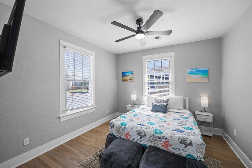 The primary bedroom features plenty of natural light