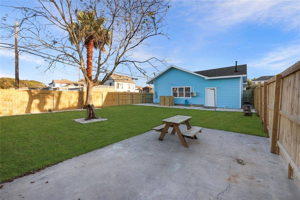 Spacious backyard enclosed by a brand new fence and freshly laid grass