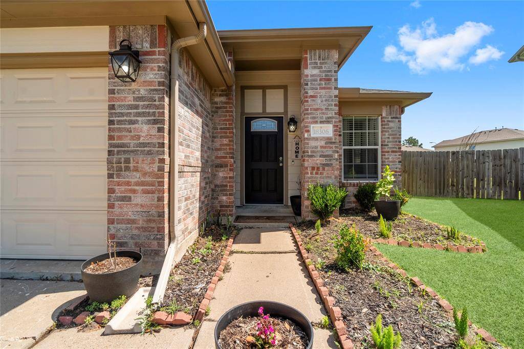 A charming entryway with welcoming touches—this front path leads straight to your next chapter.