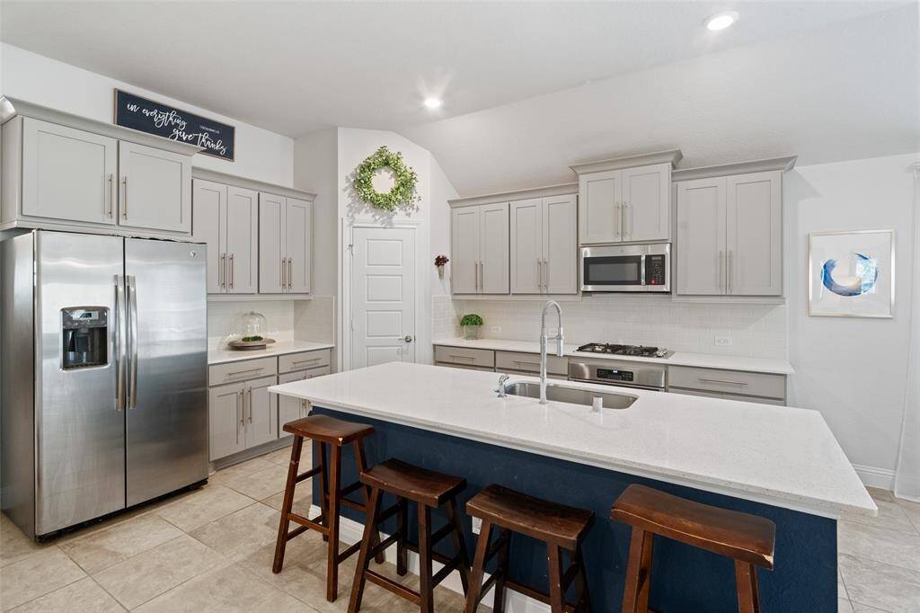 Island kitchen with gas appliances.