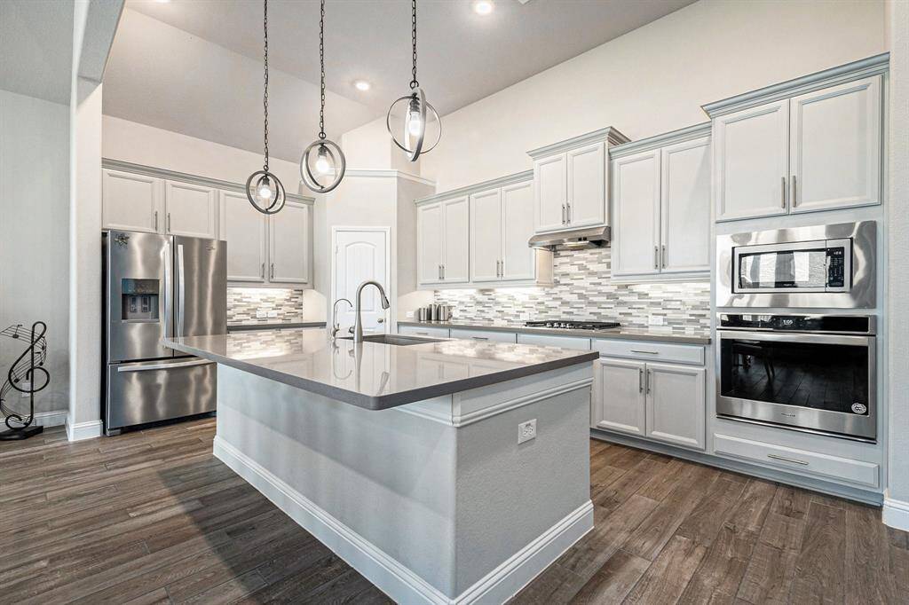 Chef's dream kitchen, boasting a massive center island, bright cabinetry, and a spacious walk-in pantry—perfect for cooking, entertaining, and creating unforgettable moments!