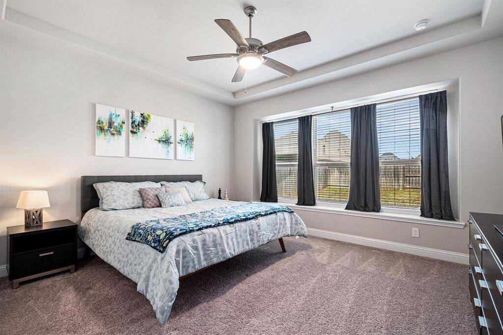 Spacious primary bedroom with high ceilings and a private en suite.