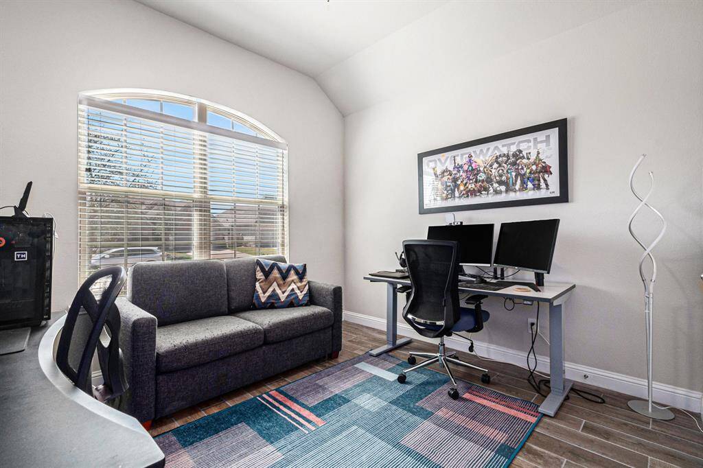 The versatile secondary bedroom is currently being used as a home office, offering beautiful views of the front yard.