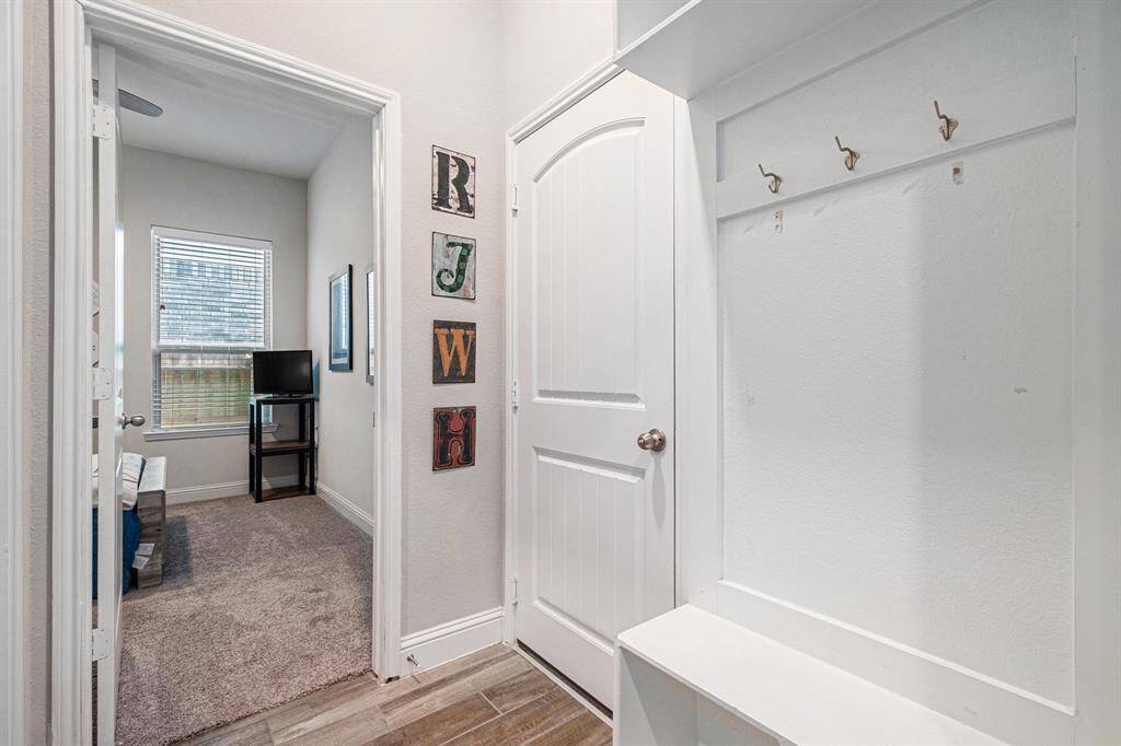 A charming mud bench just off the welcoming entry adds both style and functionality, providing the perfect spot for organizing shoes, bags, and everyday essentials.