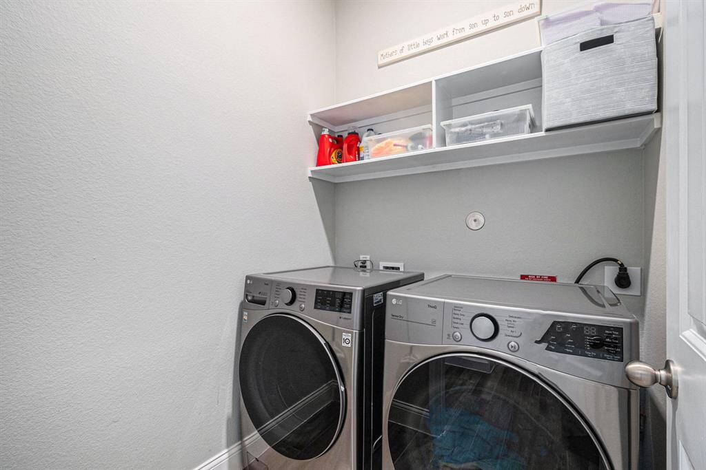 Laundry room offers storage, making it both practical and efficient for all your laundry needs.