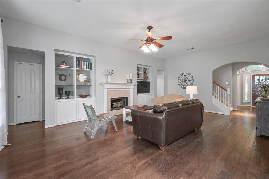 Another view of the living room, bookcases and fire place.