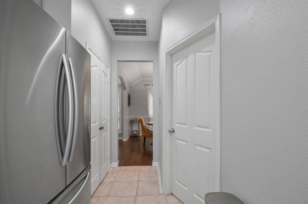 Kitchen has easy access to dining room through a short hall, where the Elfa shelved pantry and laundry room reside.