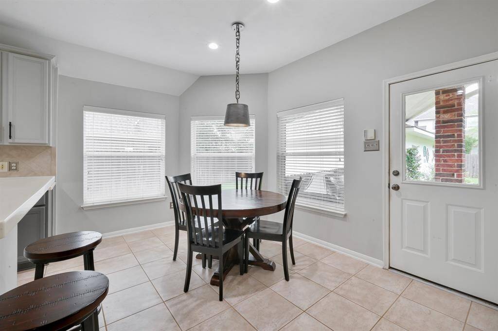 Another view of the breakfast area in the kitchen with backdoor to patio in view.