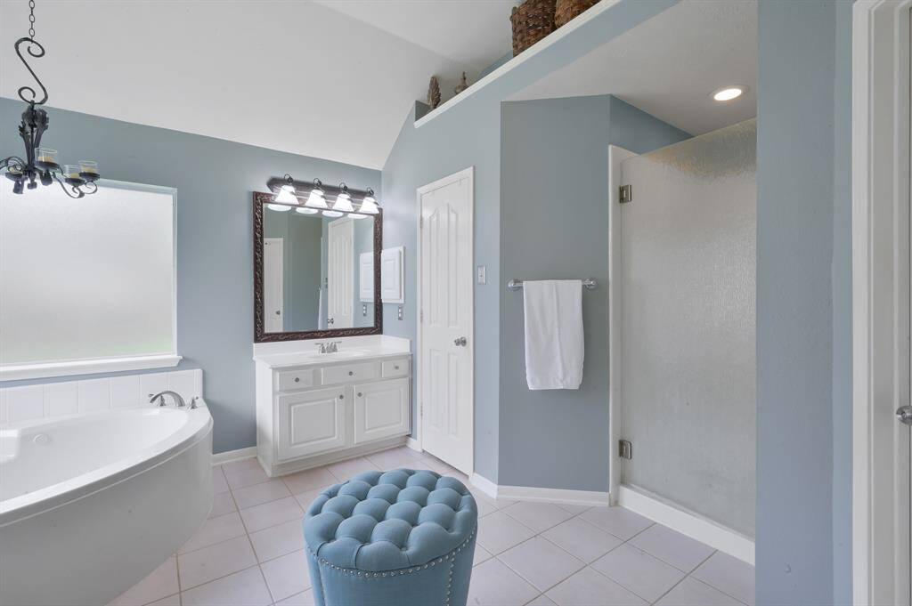 Another view of the primary bath with separate shower.