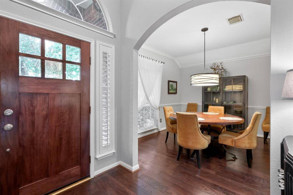 The dining area includes a modern pendant light, creating a warm and inviting atmosphere.