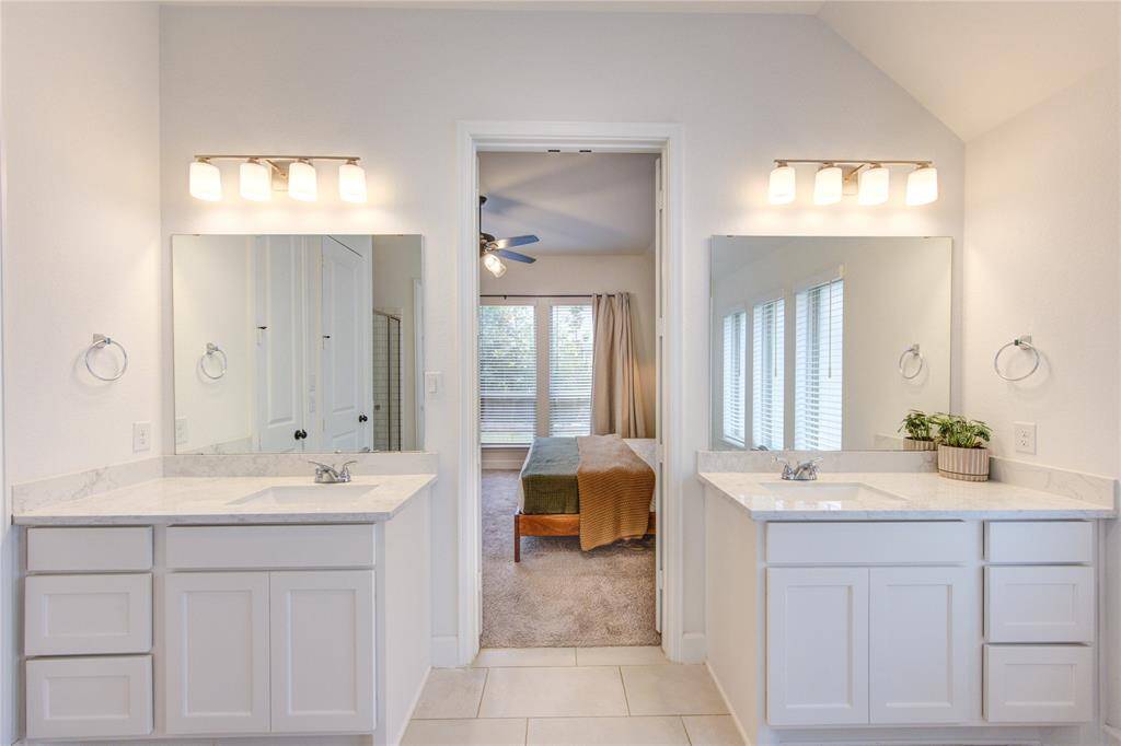 Primary bath includes dual vanities, subway tile, glass enclosed shower, xl freestanding soaking tub, and extended walk-in closet upgrade.