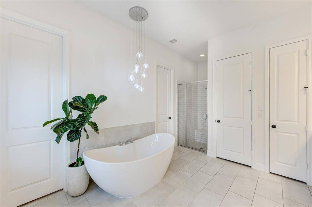 Check out this xl freestanding soaking tub framed by a beautiful chandelier!
