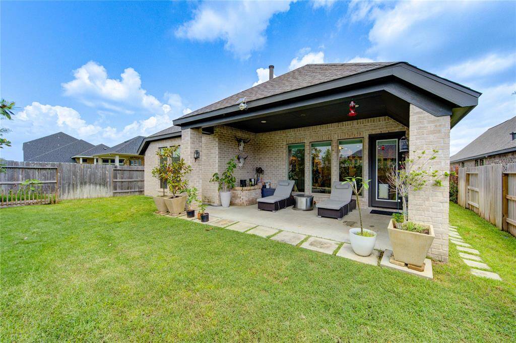 Enjoy the mature trees and thoughtful landscaping of the ‘secret garden’ backyard