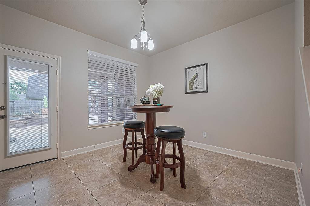 The breakfast area overlooks the large covered patio and the pool.