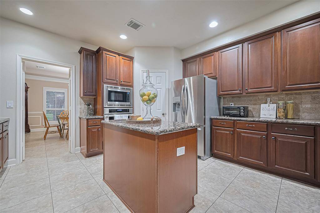 The kitchen has thermador appliances, a kitchen island, walk in pantry, lots of storage and counter space.