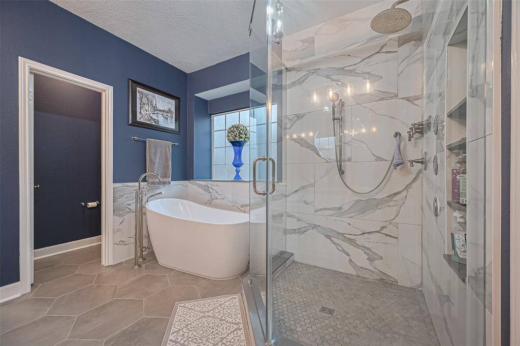 The shower had a rose head on top and a handheld one on the side.