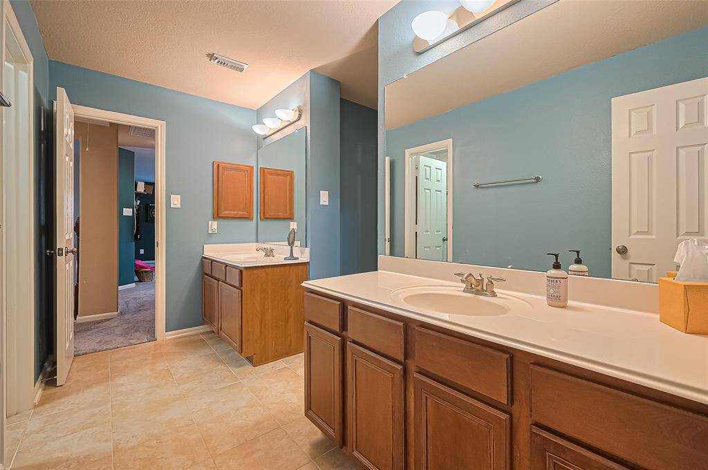 The ensuite has dual sinks and also leads to the gameroom as well as the media room.