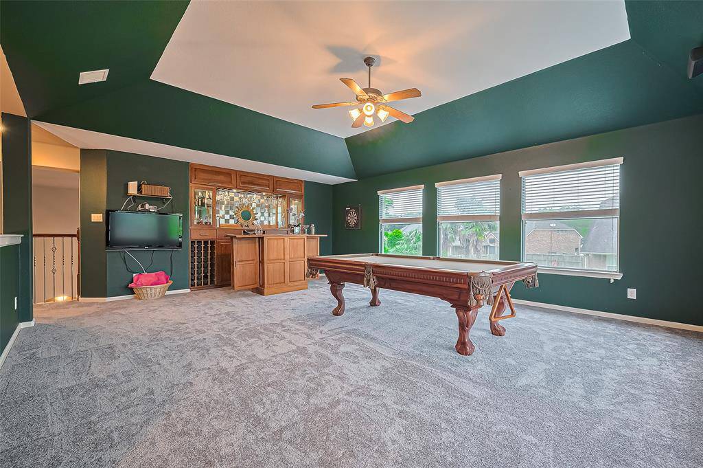 The game room also comes with a custom built in bar to the far back.