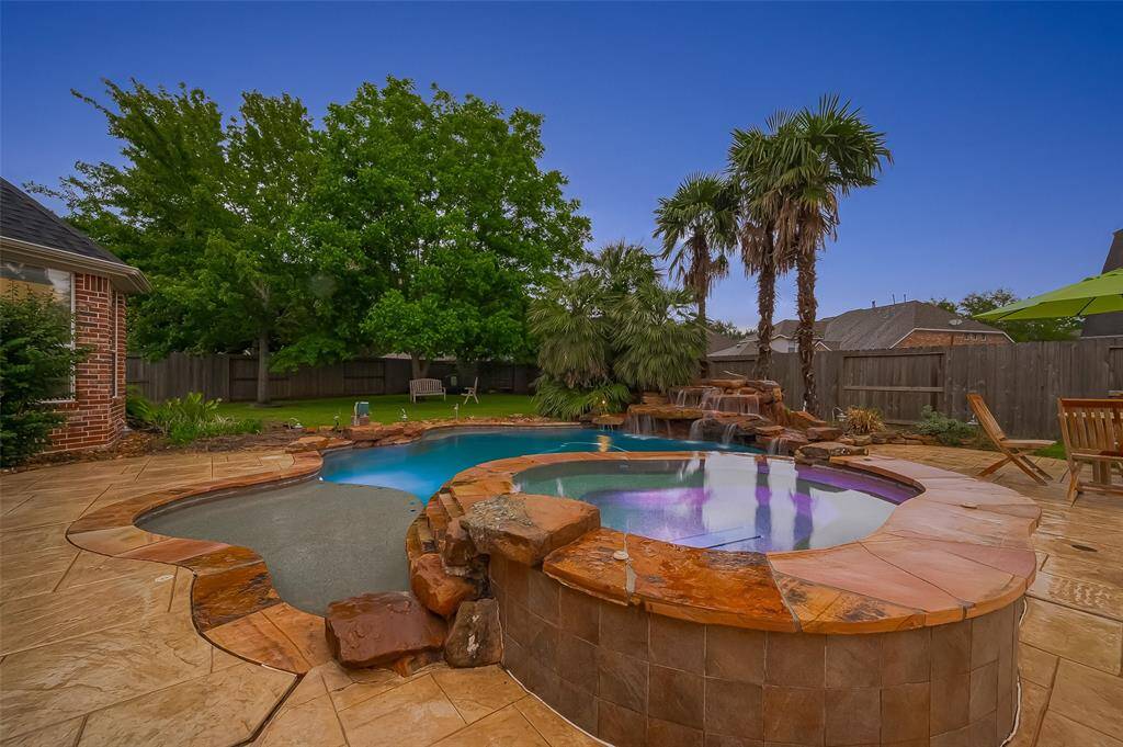 The waterfall feature is the perfect backdrop. The pool and spa look beautiful with the lights.
