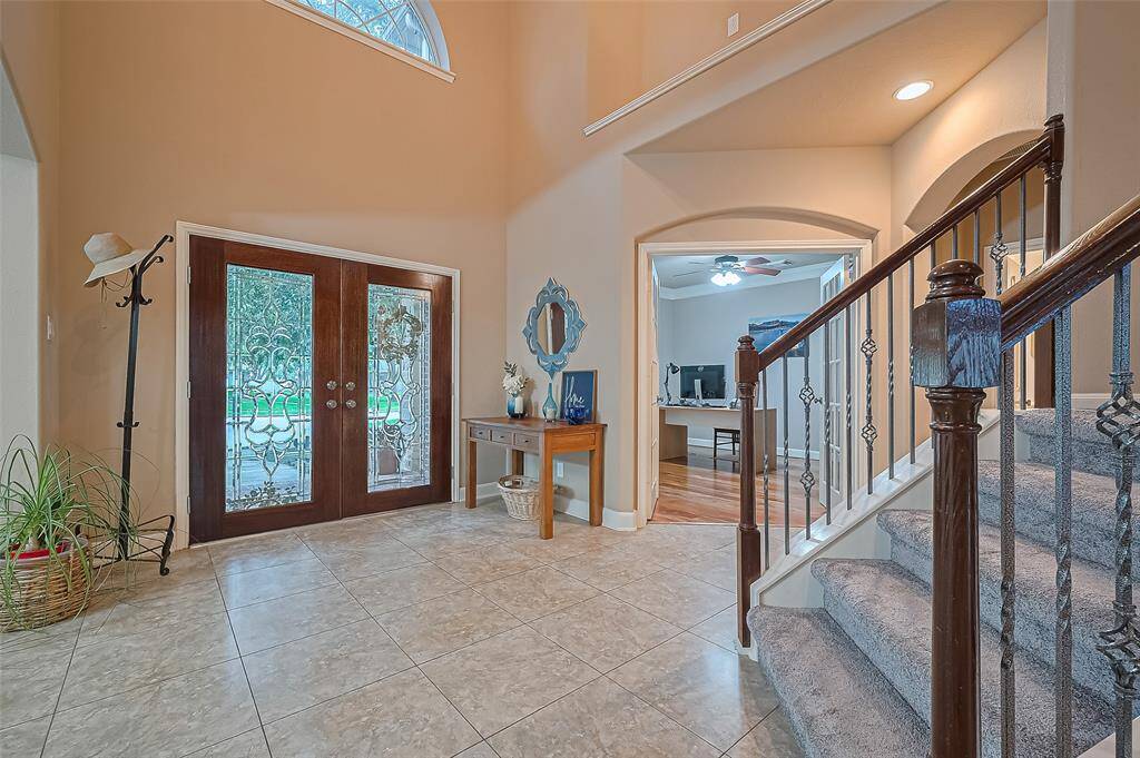 The spacious hallway has the study on one side and the formal dining room on the next.