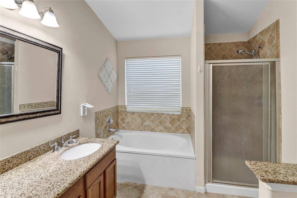 Primary room bathroom has a separate shower/garden tub