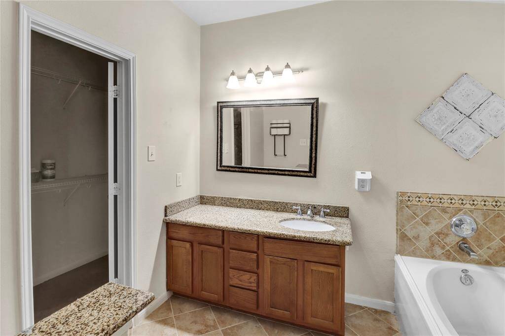 Primary room bathroom with a view of the closet