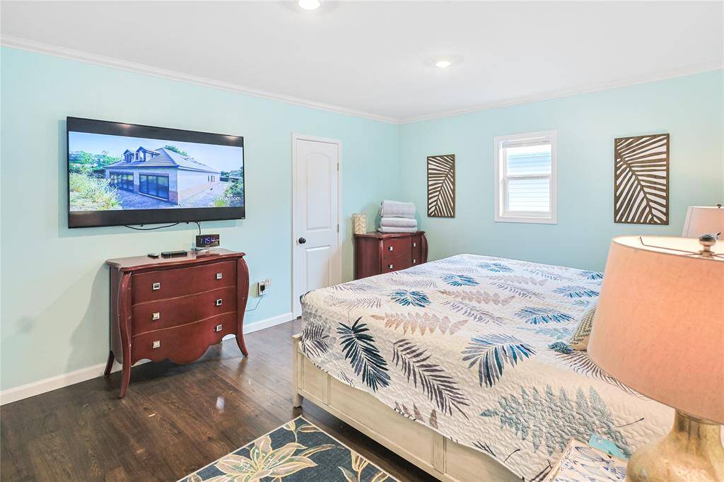 This bedroom is freshly painted with beautiful wood floors.