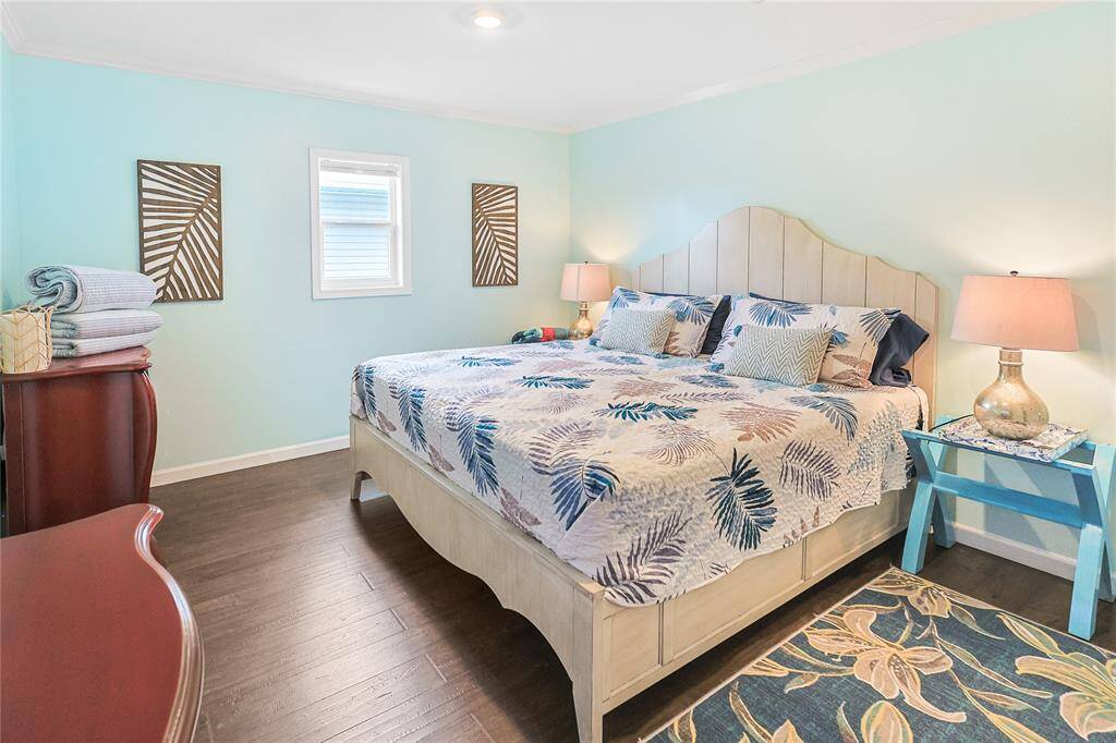 Bright bedroom with beautiful wood floors and ample space.