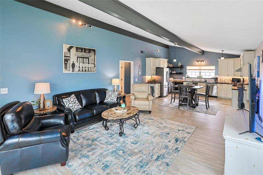 Gorgeous flooring, fresh paint, soaring ceilings, and an open-concept layout come together to make this home feel stylish, spacious, and move-in ready.