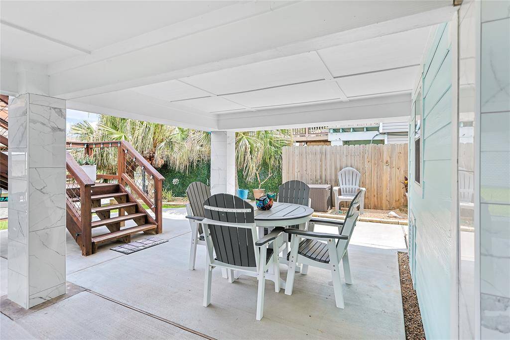 Beautifully boarded ceilings elevate the covered ground floor patio, adding a touch of style and charm to this relaxing waterfront retreat.