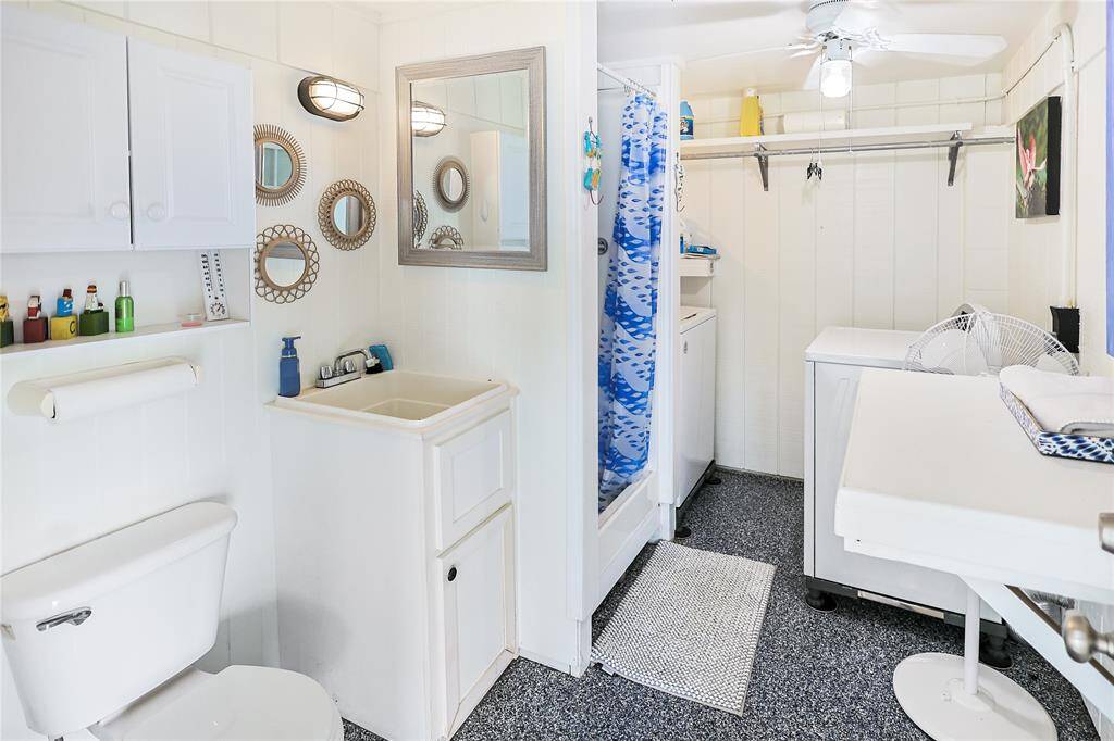 The ground floor bathroom doubles as a functional laundry room, complete with a brand-new washer and dryer- perfect for convenience and efficiency.