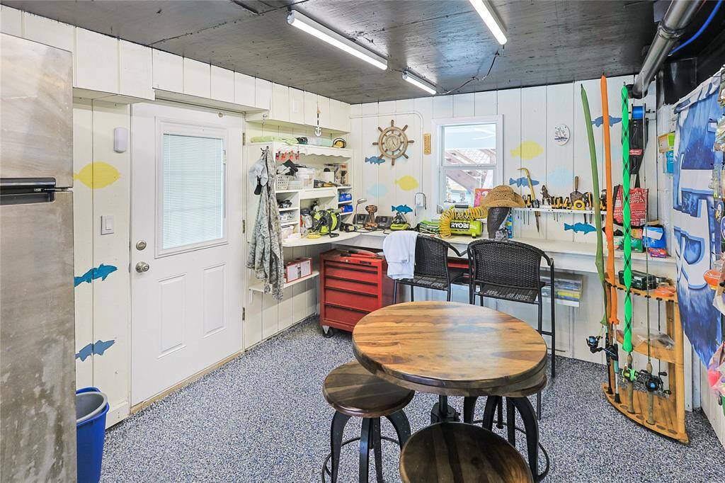 Versatile garage space includes a dedicated workshop area- ideal for hobbies, projects, or extra storage to support your waterfront lifestyle.