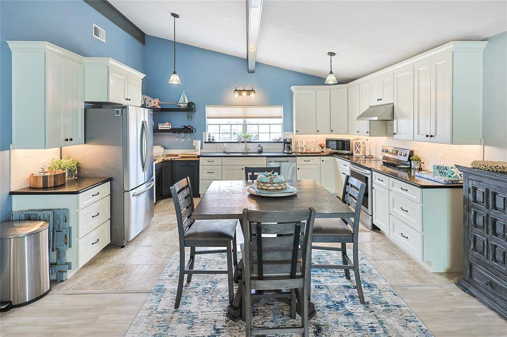 Enjoy effortless entertaining in this open-concept kitchen that flows seamlessly into the bright and airy living room- creating a welcoming space filled with natural light and coastal charm.