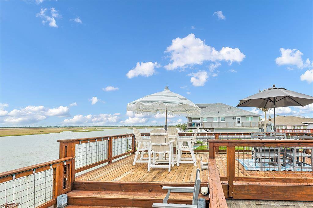Gorgeous private second-story deck has room to relax and entertain for those warm nights by the bay.