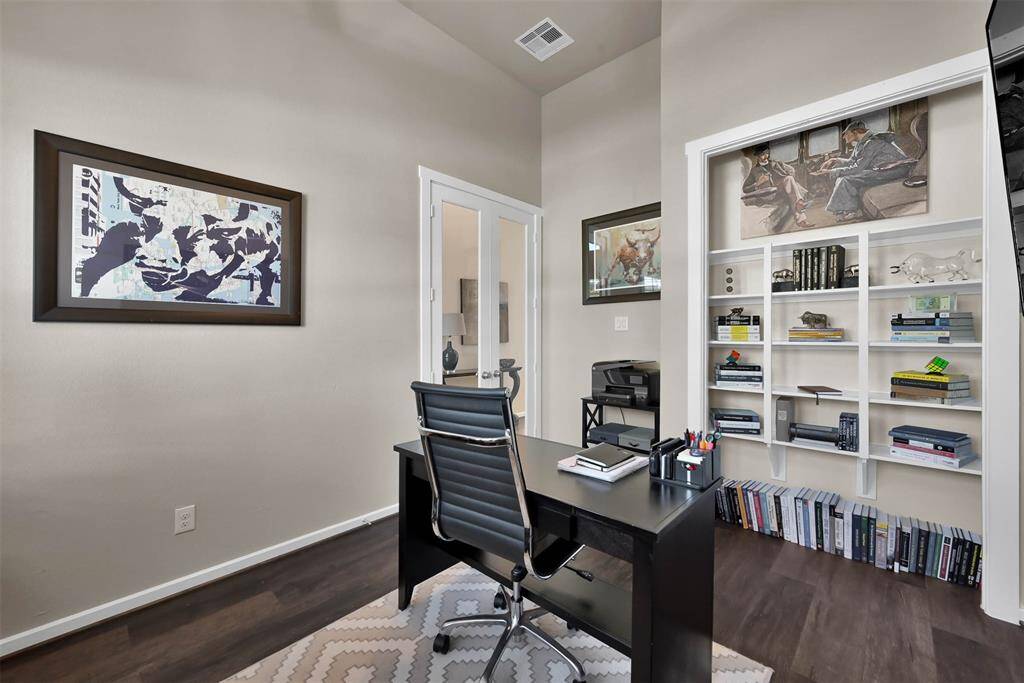 This photo showcases a modern home office. Seller converted closet with built-in white bookshelves.