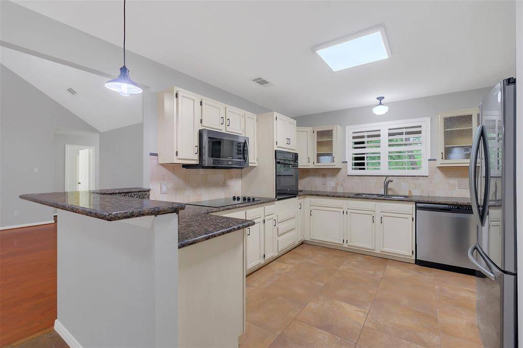 Kitchen with bar area and built in oven