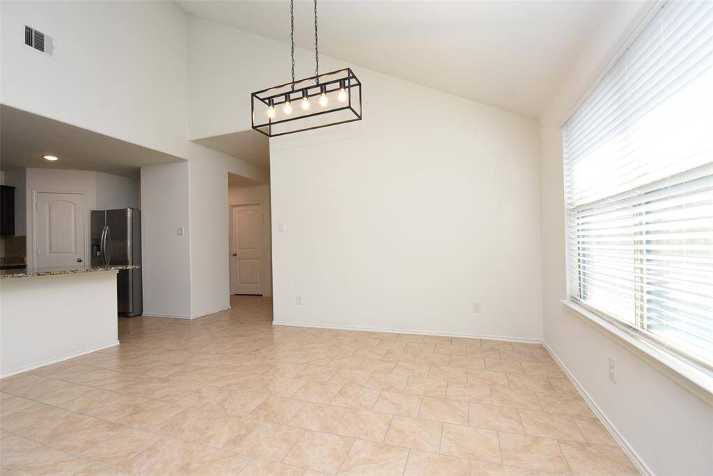 Large dining table can easily fit in the eating area.