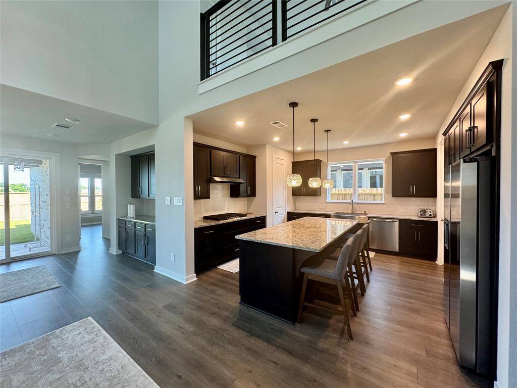 Stainless appliances with large granite island kitchen.