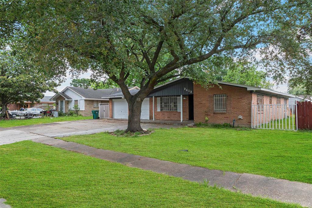 Charming single-story brick home with a large front yard and mature tree. The property features a paved driveway leading to a one-car garage. Ideal for buyers seeking a cozy and inviting residence.