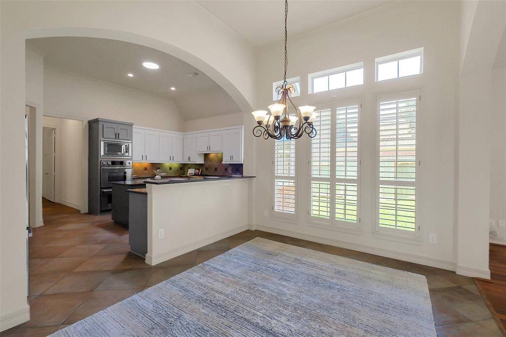 Large breakfast nook/casual family dining area is open to the kitchen with a breakfast bar.