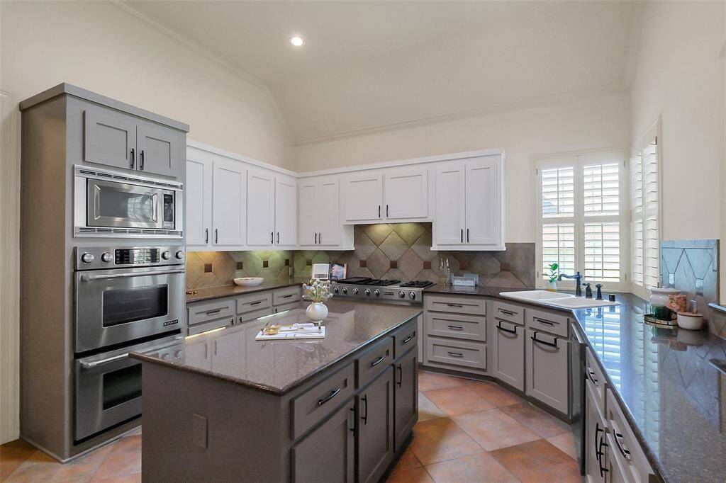 Chef's dream island kitchen with double ovens and tons of counter space.