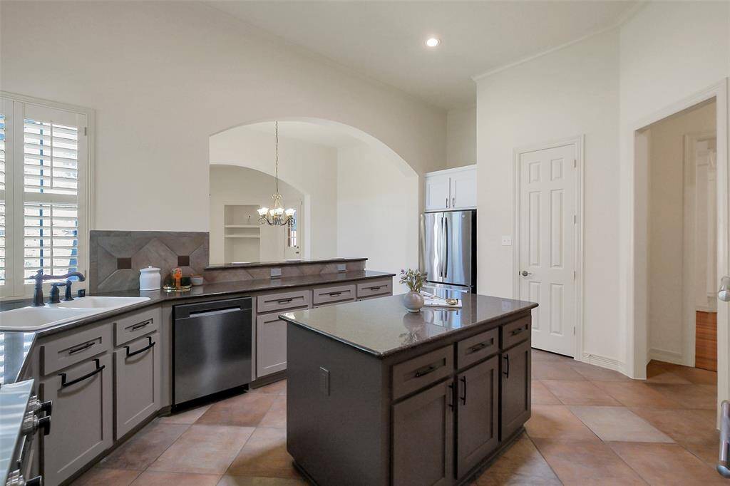 The kitchen features stainless appliances, double farmhouse sink and large pantry.