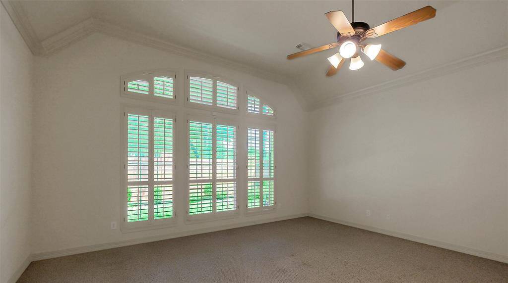 Large primary suite with high ceilings and back yard view.